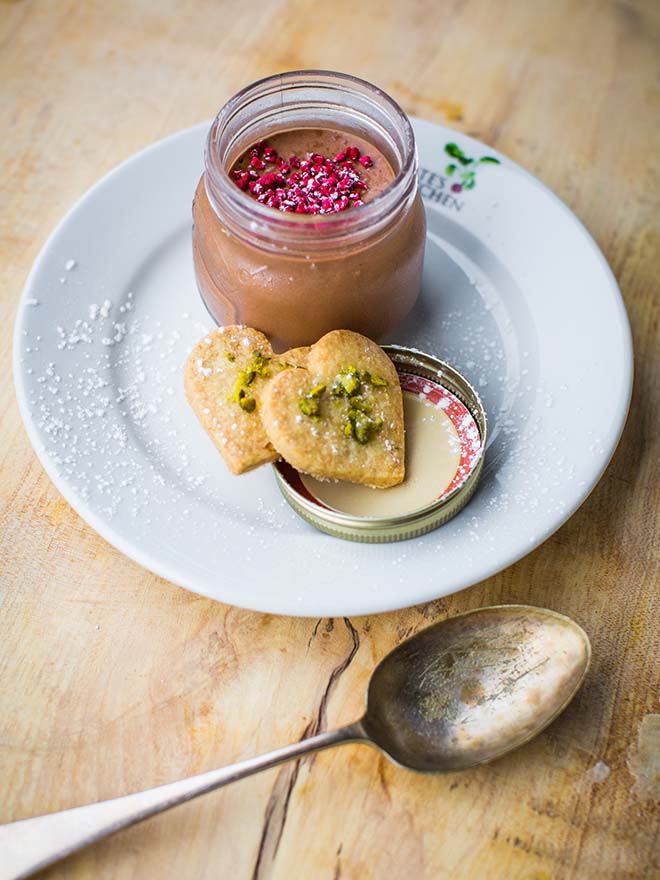 rich chocolate pot with dehydrated raspberry pieces and heart shaped shortbread biscuits