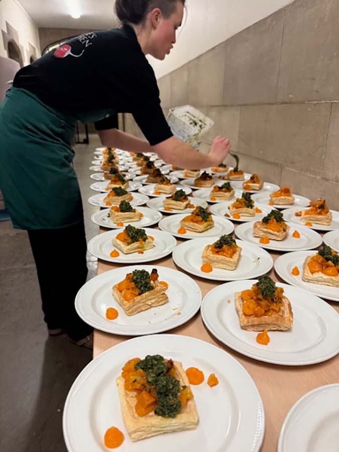 chef plating up mains for vegan wedding feast in bristol chef plating up mains for vegan wedding feast in bristol