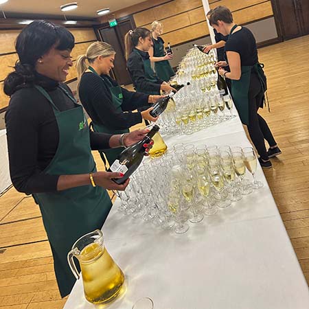 kates kitchen service staff pouring sparkling wine for wedding